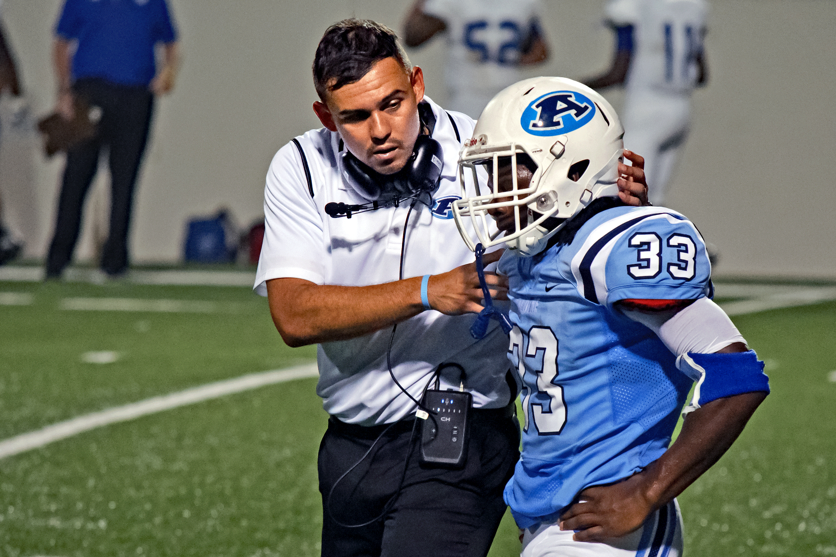 Aldine head coach James Kowalewski gives pointers to Mustang RB Michael McLennon during the 2016 season.
