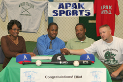 Elliot on Signing Day with Family and Coach Williams